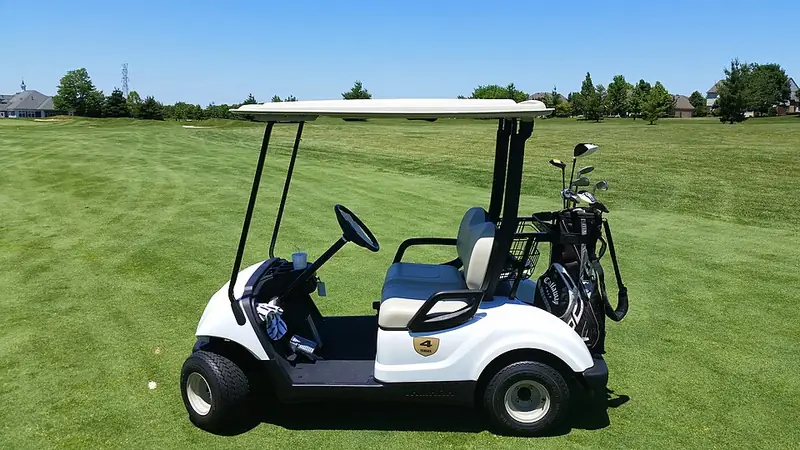 Golf cart parked on a green fairway