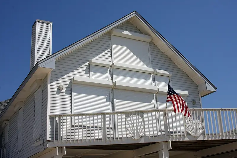 Storm shutters covering the windows and doors of a home