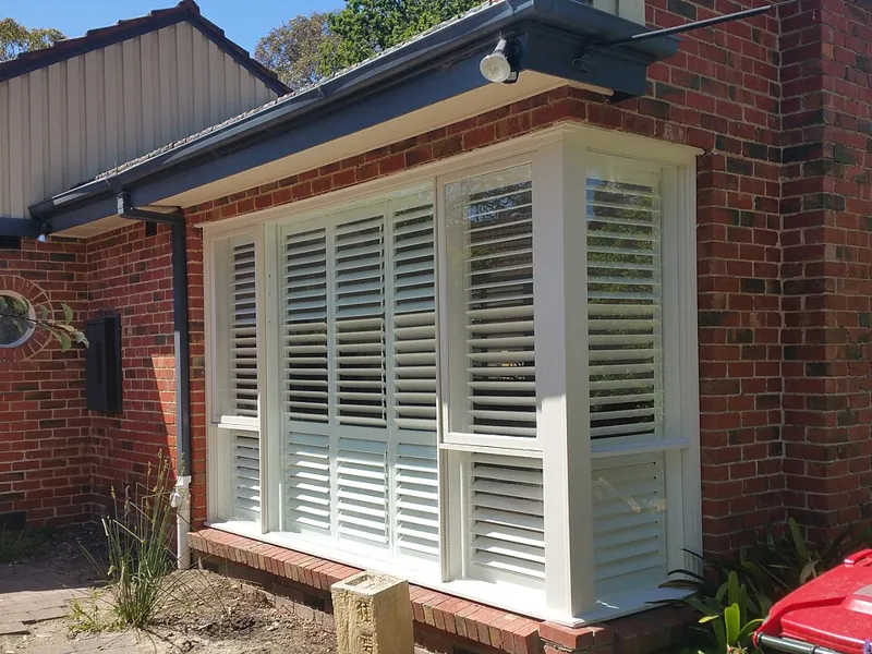 White plantation shutters on a window