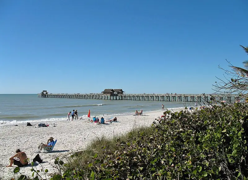 Naples Pier stretching into the Gulf from the beach